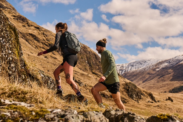 male runner in compression calf sleeve run over rocks Stock Photo - Alamy